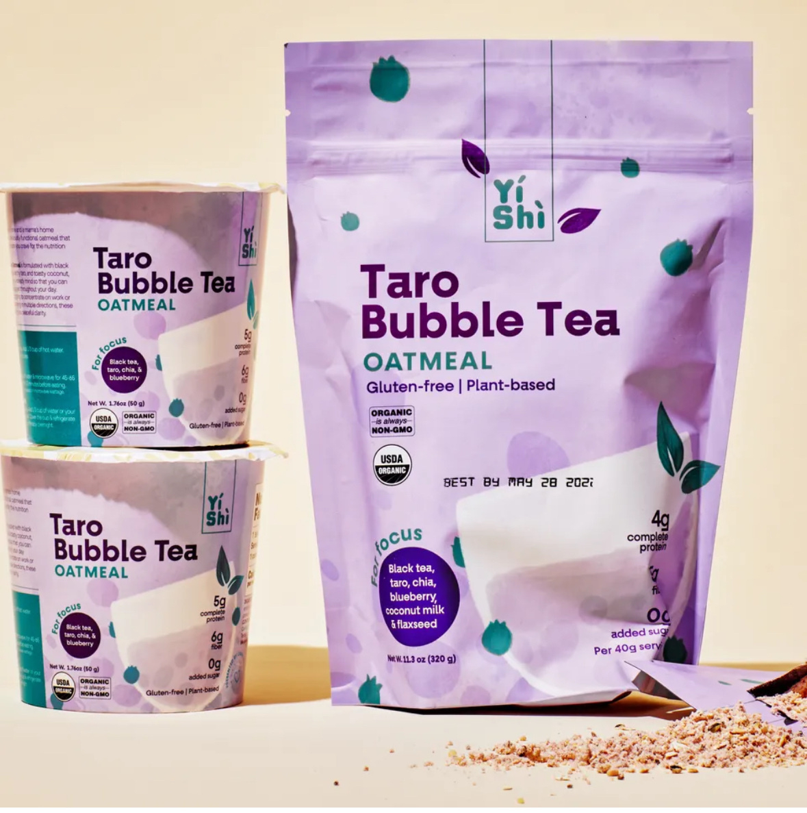 Packaged food of taro flavored bubble tea. The package is purple. On the right is a multi serve bag. On the left are two single servings stacked two high. 