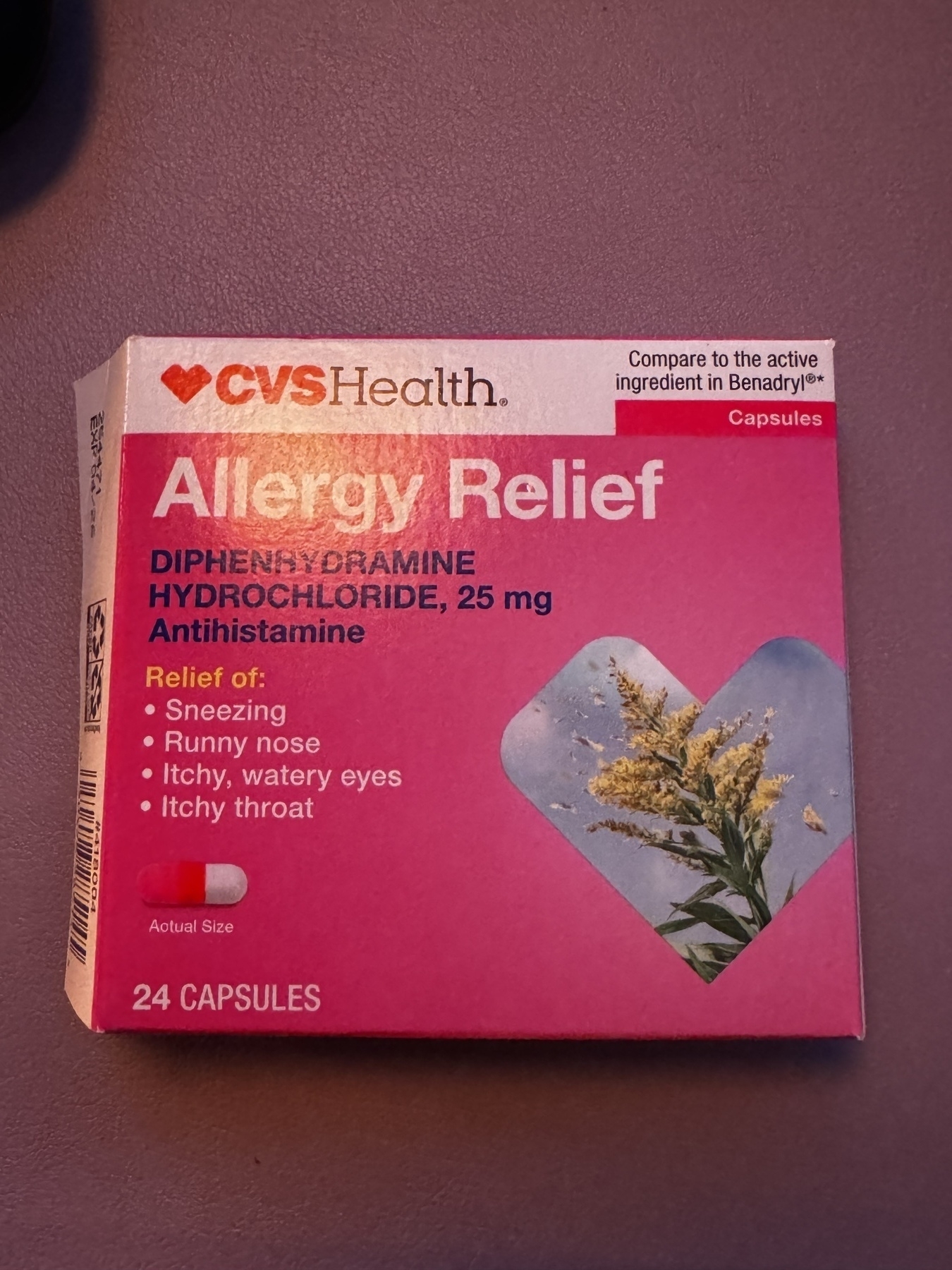 A box of CVS Health Allergy Relief capsules displaying the list of symptoms it relieves, the active ingredient, and a visual representation of the capsule size.