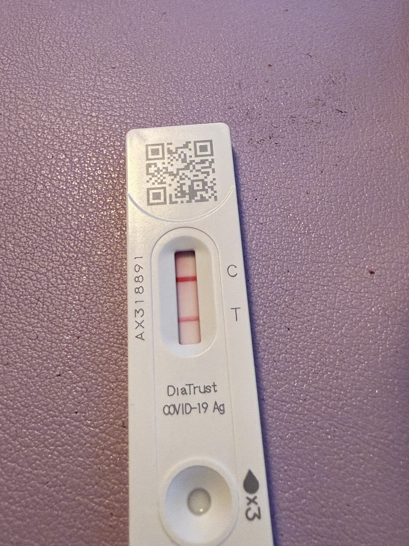 Positive Covid test on a purple surface 