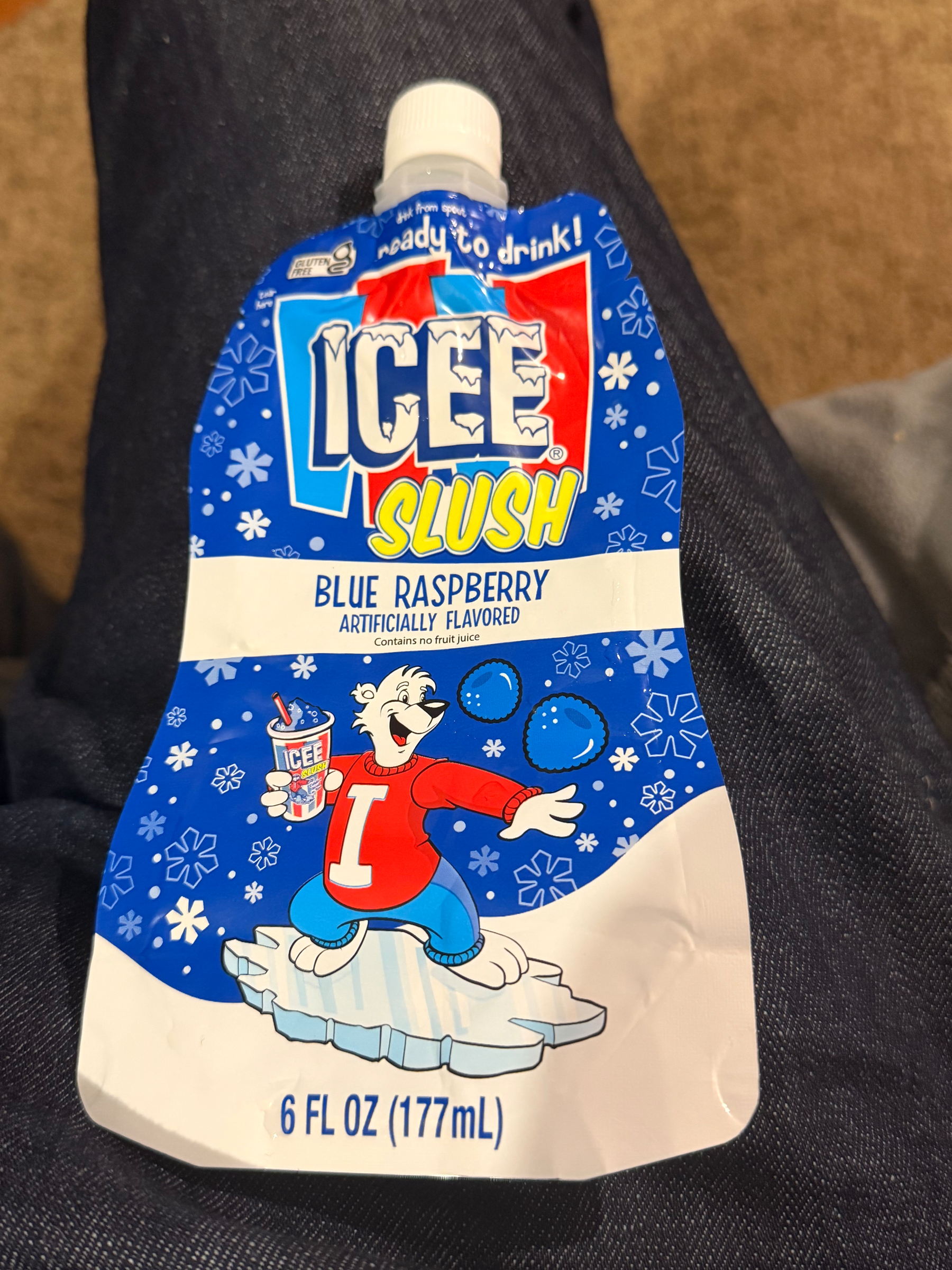 Blue raspberry ICEE Slush drink pouch, 6 fl oz, featuring the polar bear mascot surfing on ice while holding an ICEE cup. Snowflake pattern on blue background.​​​​​​​​​​​​​​​​